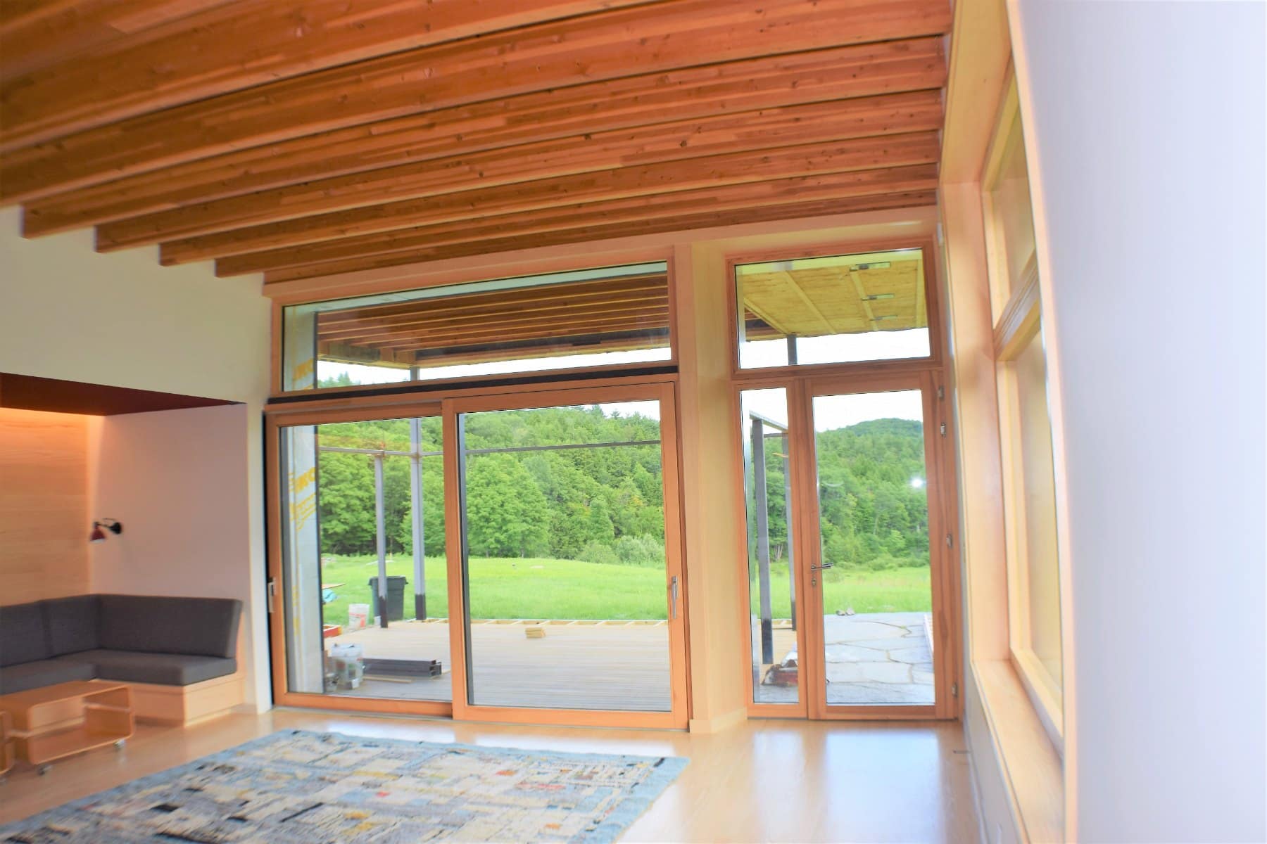 Coulissant à levage bois-aluminium pour maison passive avec imposte vitrée
